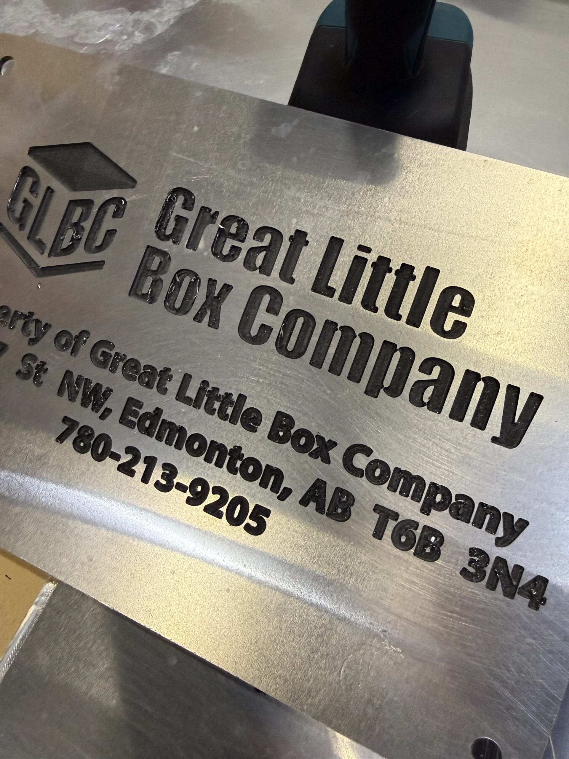 CNC-engraved aluminium placard with the Great Little Box Company logo and lettering